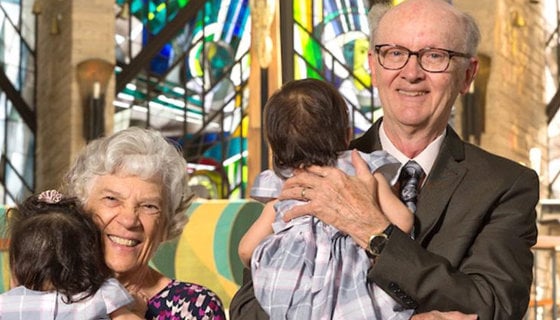 Corinne and Roger Vogel holding a two of their children