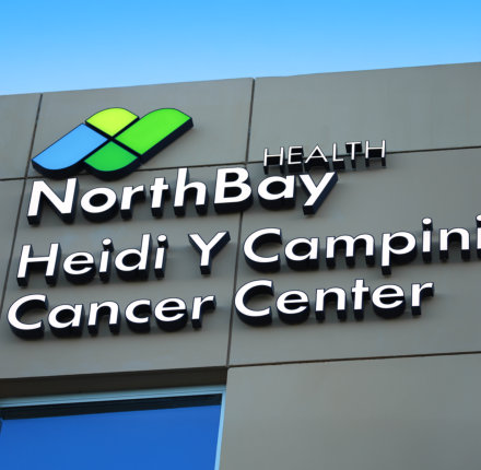 Close up of the new building signage starting with Northbay Health&rsquo;s logo with the Heidi Y Campini Cancer Center name underneath.