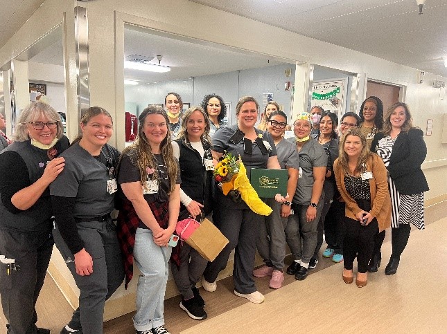 Large group of nurses and staff celebrating together