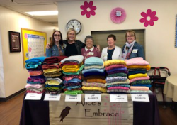 Diane Lewis and her fellow volunteers pose with donated items