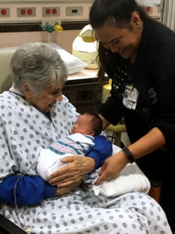 Anna Tiss, RN, (right) checks to assure that trained cuddler Gayle Ratliff is comfortable.